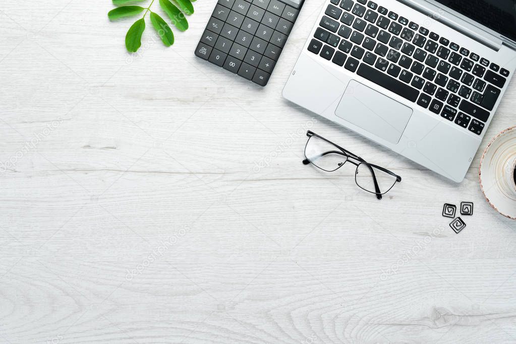 Office white desk. Laptop and accessories. Top view. Free space for your text. Flat lay.