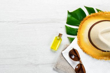 Beyaz ahşap arka planda güneş gözlüğü ve şapka. Üst Manzara. Boş kopyalama alanı.
