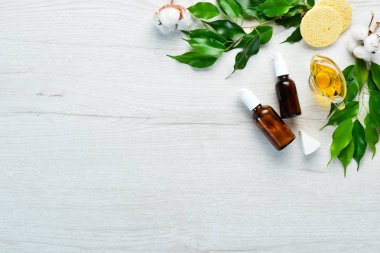 Yüz bakımı. Yüz kremli şişeler, pipetli şişeler. Beyaz ahşap bir arka planda. Düz yatıyordu.