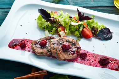 Kiraz soslu dana madalyonu ve sebze. Bulaşıklar, yemek. Üst Manzara. Metnin için boş yer.