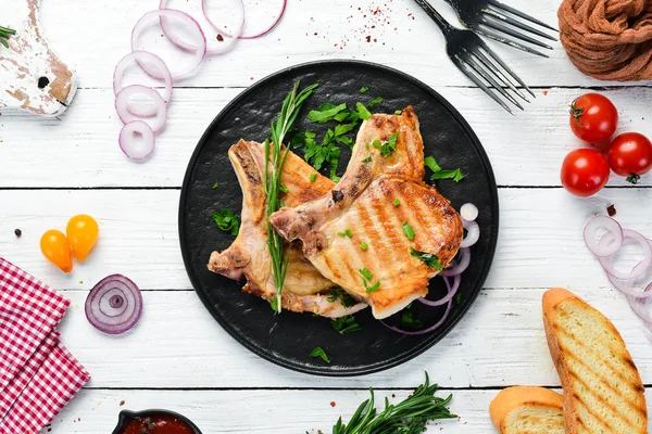 Pork Steak Bone Rosemary Greens Black Plate Top View Free — Stock Photo, Image