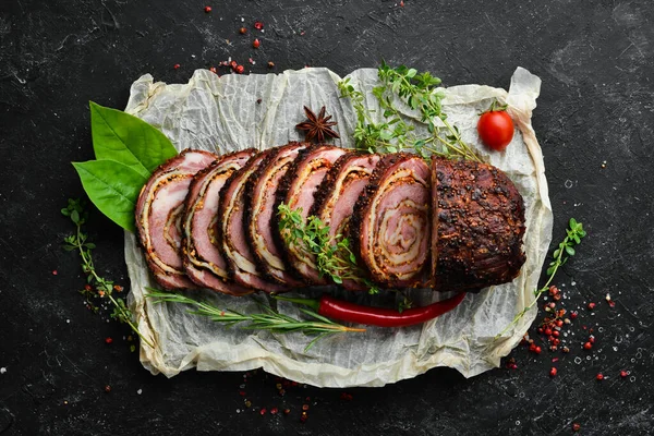 Baked veal and cheese roll with spices and rosemary. Top view. Rustic style.