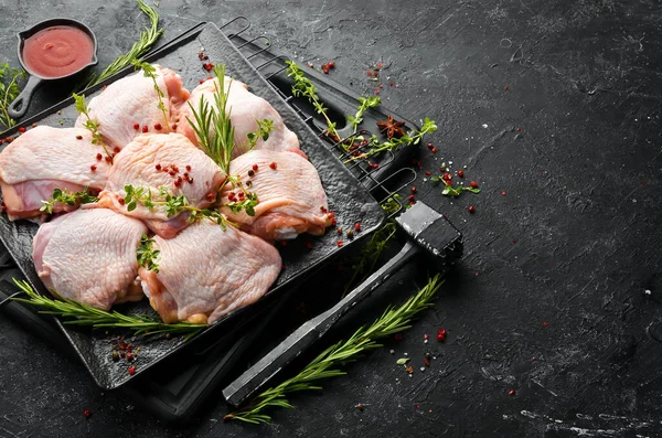 Raw chicken thighs with ingredients and spices on kitchen background. Meat. Top view. Rustic style.