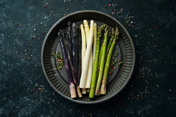 Siyah arka planda organik kuşkonmaz. Bir çift renkli kuşkonmaz. Üst Manzara. Metnin için boş yer.