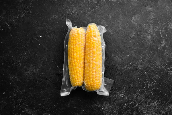 Frozen fresh corn. Food supplies. Top view. Free space for your text.