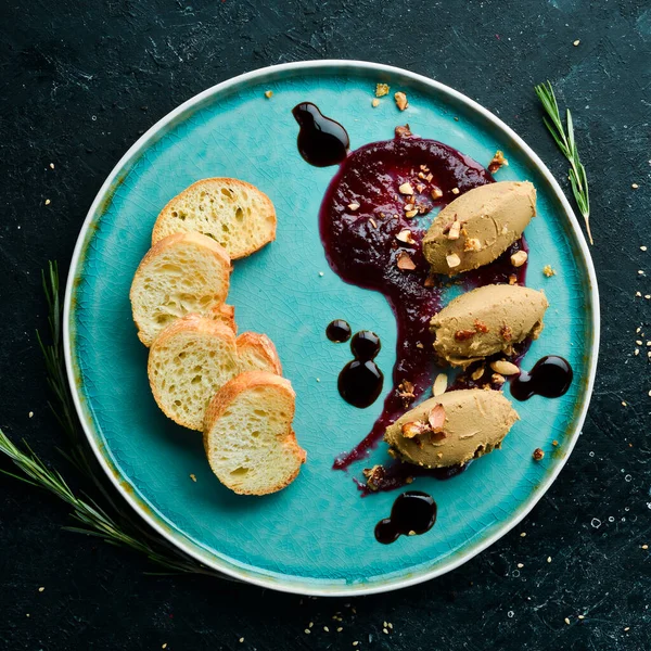 Kaz ciğeri ezmesi, soya sosu ve siyah taştan bir arka planda tost. Üst Manzara. Kırsal biçim.