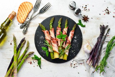 Domuz pastırması ve baharatla pişirilmiş kuşkonmaz. Üst Manzara. Metnin için boş yer.