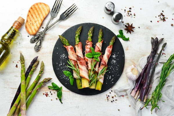 Domuz pastırması ve baharatla pişirilmiş kuşkonmaz. Üst Manzara. Metnin için boş yer.