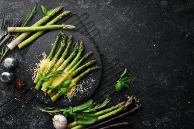Siyah taş tabakta peynirli ve fesleğenli kuşkonmaz. Üst Manzara. Metnin için boş yer.