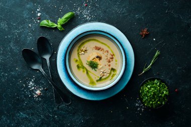 Sağlıklı yiyecekler. Siyah taşlı tabakta mantar kremalı çorba. Üst Manzara. Kırsal biçim.
