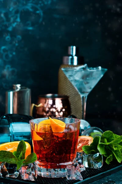 Traditional Negroni cocktail on black stone background. Menu bar. Alcohol.