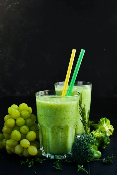 Green smoothies. Broccoli and grape smoothies. Healthy drinks. Top view. On a black background.