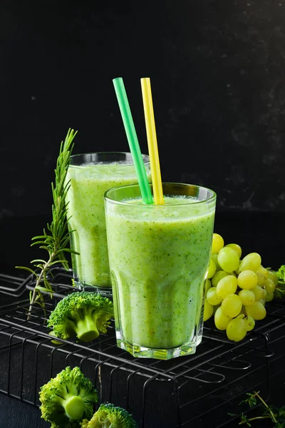 Green smoothies. Broccoli and grape smoothies. Healthy drinks. Top view. On a black background.