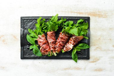 Siyah taş tabakta roka ve balzamik soslu Prosciutto. Antipasto. Üst görünüm.