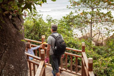 Tropikal bir ülkede bir çocukla seyahat. Dağlarda bir ahşap merdiven üzerinde zam. Arka plan resmi.