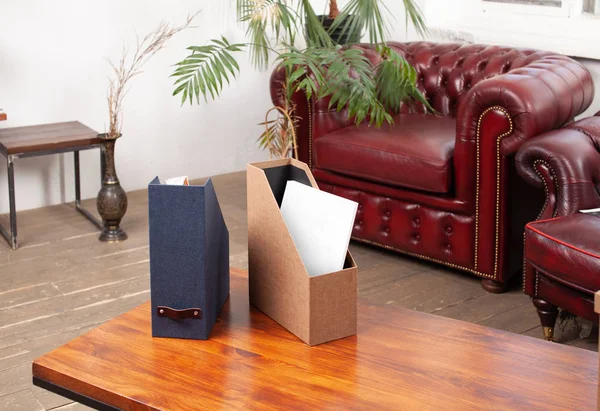 Box with folded things in the interior of the apartment