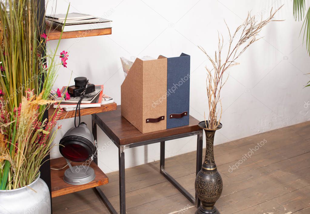 Box with folded things in the interior of the apartment