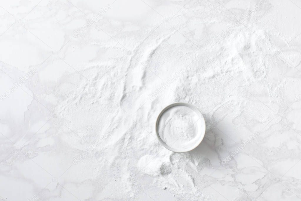 Baking soda in a bowl on the marble countertop