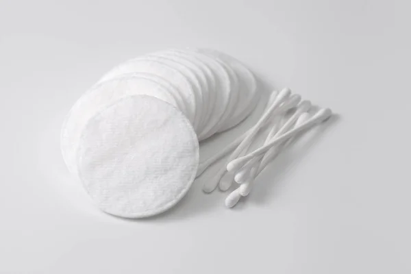 Una pila de almohadillas de algodón y hisopos de algodón en gris —  Fotos de Stock