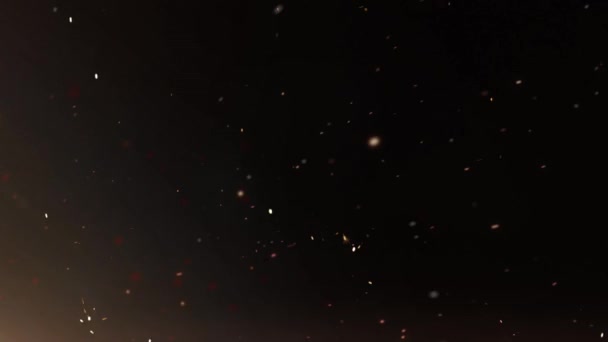 Particules et étincelles Arrière-plan La boucle 4K présente un fond sombre avec une lueur dans le coin inférieur gauche et des particules de lumière et des étincelles qui traversent la scène en boucle. .