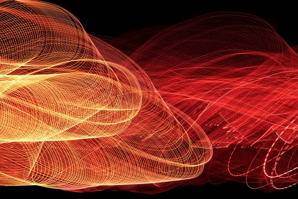 Orange and red light lines on black background. Abstract photography by long exposure.