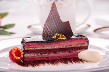 Sütlü çikolata tabağı ile dekore edilmiş çocuk oyuncağı ahududu ve bir top dondurma ile servis edilir