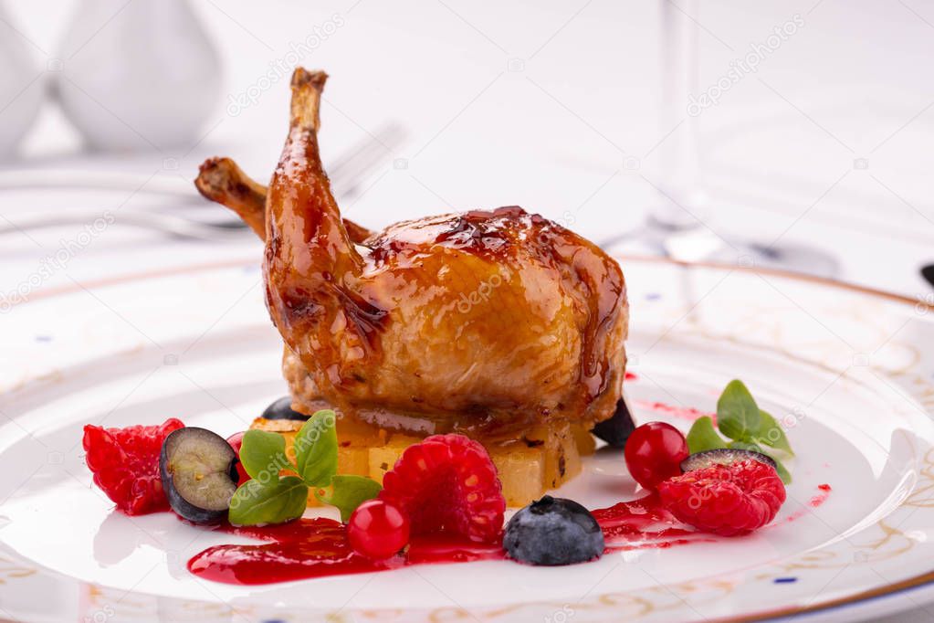 Berry mousse from fresh berries, moves with a fried quail with pineapples