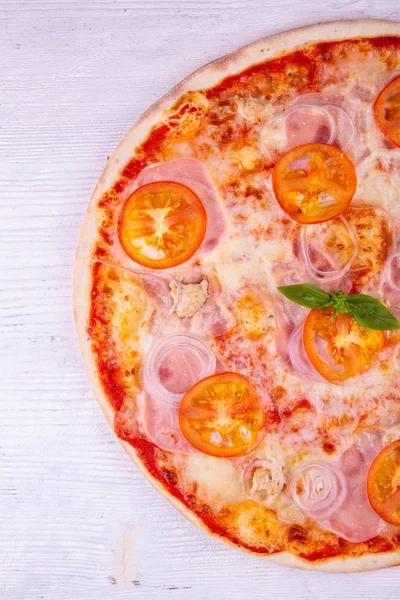 Tomatoes, onions pizza and pieces of chicken breast