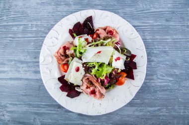 Keçi peynirli kızartma biftek salata, yabanmersini sosu servis edilir