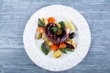 Bir ahtapot sebze ve zeytin sos ile 