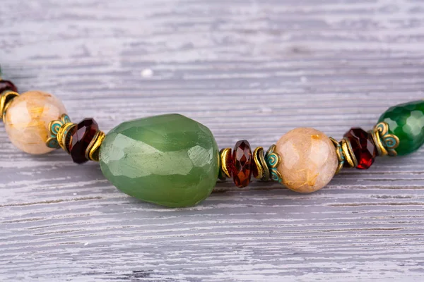 A green stone chalcedony between semi-precious stones amber rondels are inserted