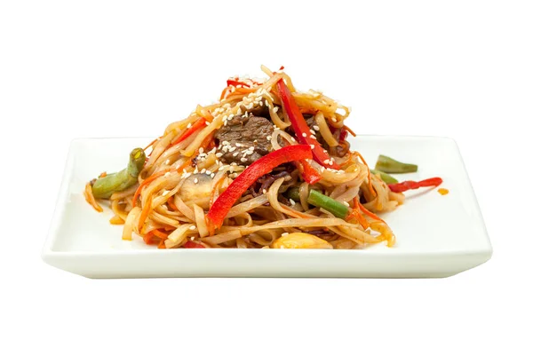 Chinese noodles with beef and vegetables on a square plate isolated from background