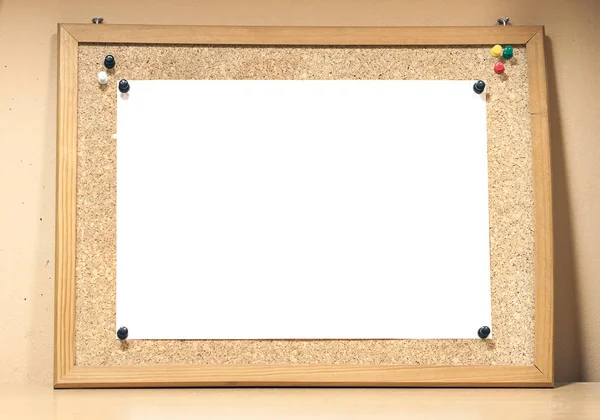 A cork board with a white sheet of paper. Background for mockup. Place for text.