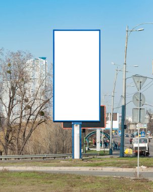 Blank vertical billboard near a highway. Background for mock-up. clipart