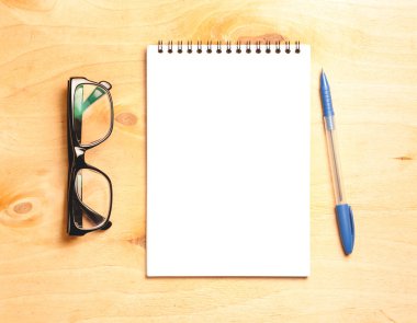 İş gerekli. Ahşap Resepsiyon arka plan üzerinde sarmal boş defter üstten görünüm