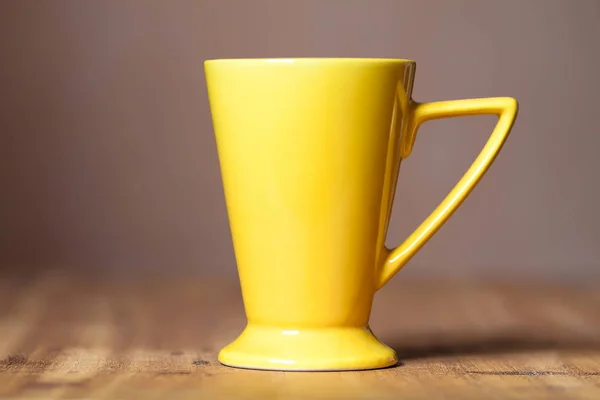 Stylish Yellow mug on the wooden table