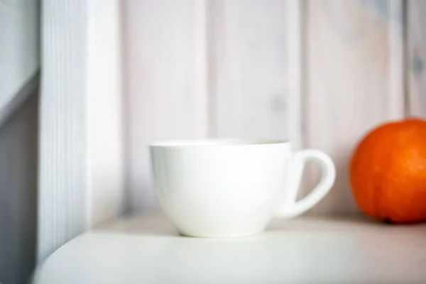 Blank white mug on kitchen table.