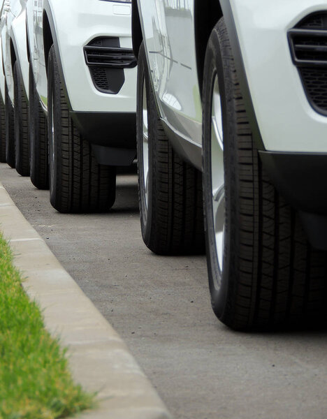 Line of the wheels of same vehicles staying on the road 