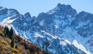 Almaty, Kazakistan, 09.25.2025. Trans-Ili Alatau Dağları 'nın arka planında bir sonbahar sabahı Kazakistan, Almaty yakınlarında bir teleferik..