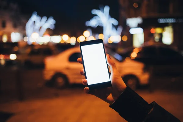 Female\'s hand holding showing smart phone