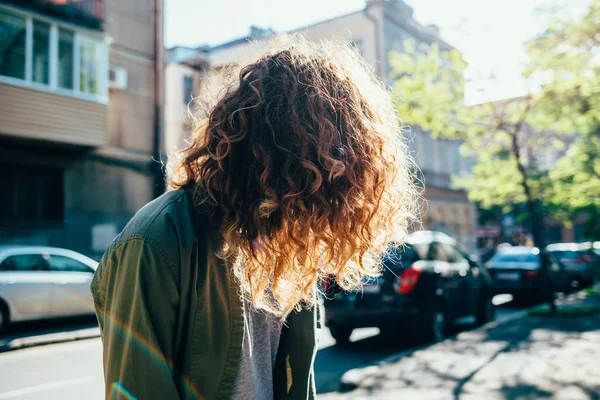 Unrecognizable girl with naturally curly hair