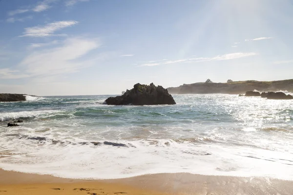 beautiful beach with waves breaking on the shore and without people