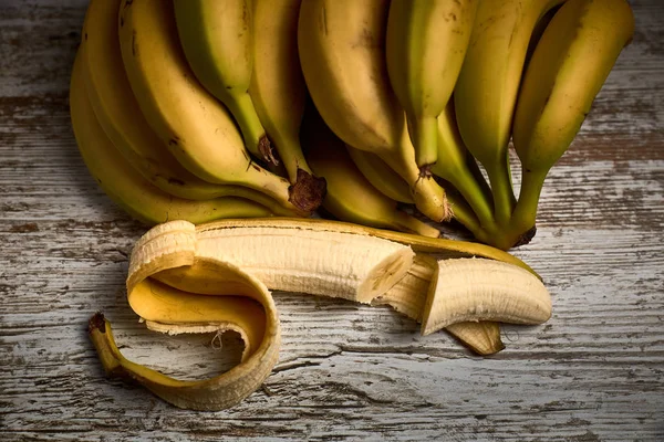 Bunch of yellow bananas on a wooden board — Stock Photo, Image