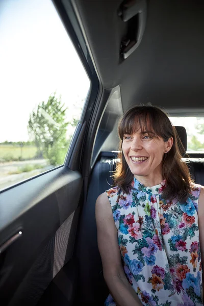 woman sitting in the backseat of a car