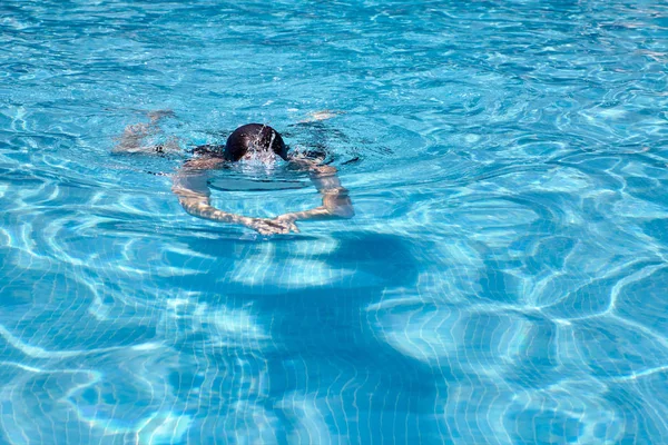 Vrouw zwemmen in een zwembad — Stockfoto