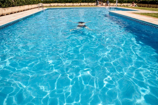 Mulher nadando em uma piscina — Fotografia de Stock