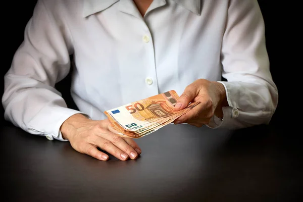 Close-up of the hand of a person handing over money. Business concept