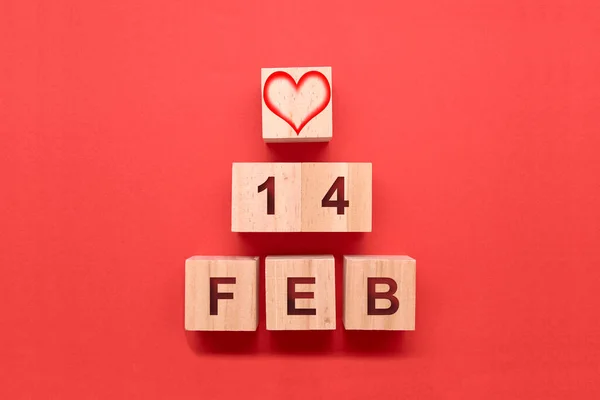 Triangle with cubes with a heart and the date 14 February. Concept of love
