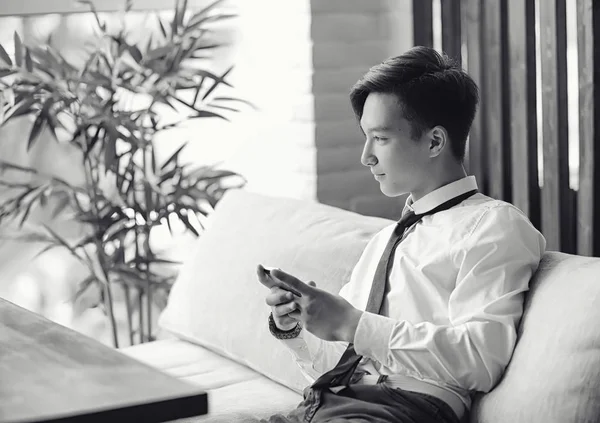 Genç Asyalı işadamı bir kafede bir ortak için bekliyor. Bu