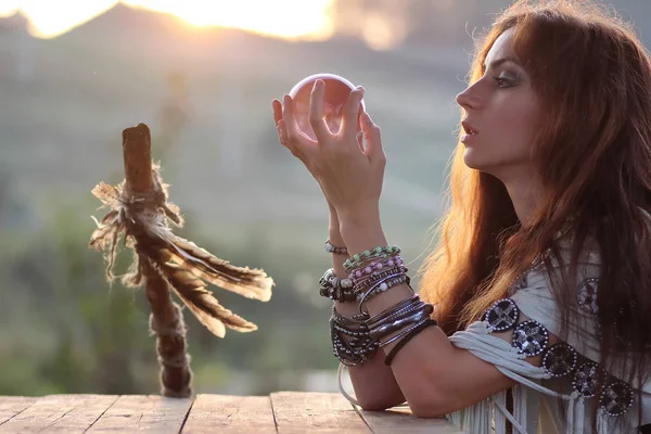 Witch with crystal ball at sunset — Stock Photo, Image